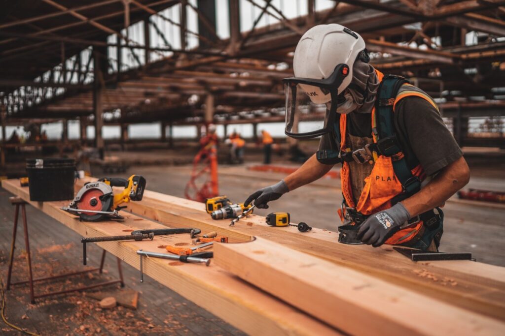 Wood worker cutting timber